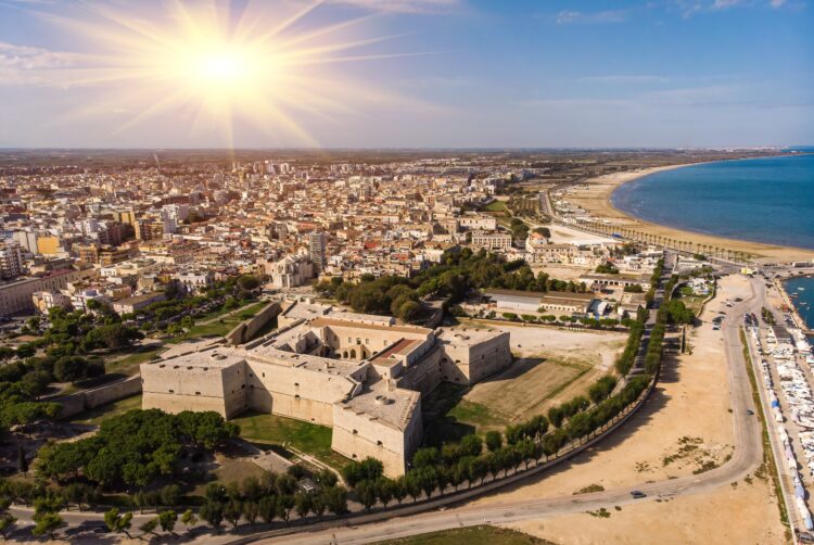 Aerial view over Castello Svevo in Puglia, Italy with the fortress in the foreground and the sea to the right. Near Trani in Puglia.