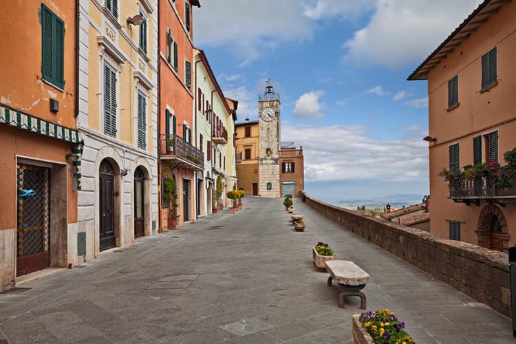 Chianciano Terme, Siena, Tuscany, Italy: panoramic street in the old town with ancient buildings, the clock tower and flower pots