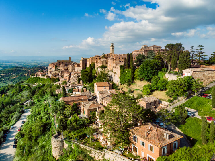 Aerial summer day view of Montepulciano town, located on top of a limestone ridge surrounded by vineyards. Vino Nobile wine territory, known worldwide for its wine and food tours. Tuscany, Italy.