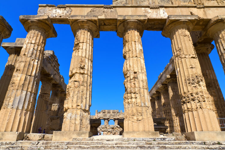 Archaeological area of ​​Selinunte in Sicily, with a close up of the temple columns and a blue sky on a sunny day at the ruins.
