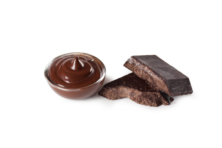 Grainy Modica chocolate rests beside a smooth swirl of cocoa - highlighting the difference in colour and texture.